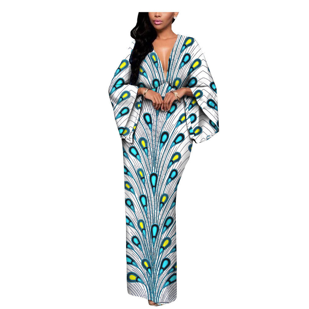 Woman in a long, flowy peacock-patterned kaftan dress, FashionRay trendy style