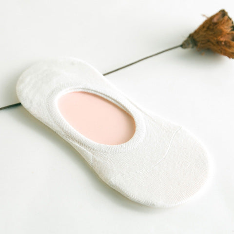 White no-show sock on a light background with dried flower, FashionRay comfort accessory