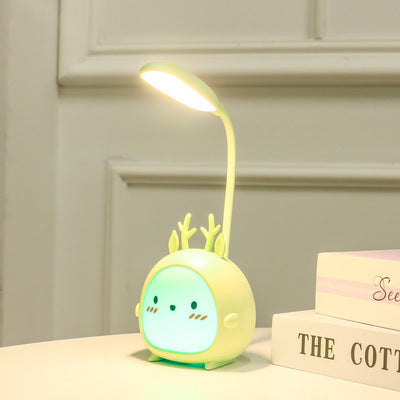 Cute deer-shaped LED desk lamp with a glowing face on a table, modern home decor by FashionRay.