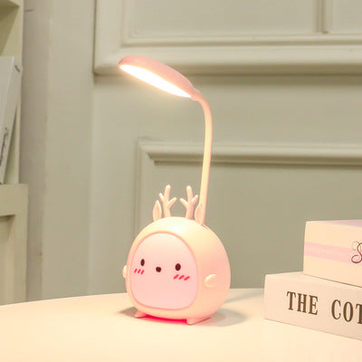 Cute pink deer-shaped LED desk lamp on a white table in a stylish room, FashionRay