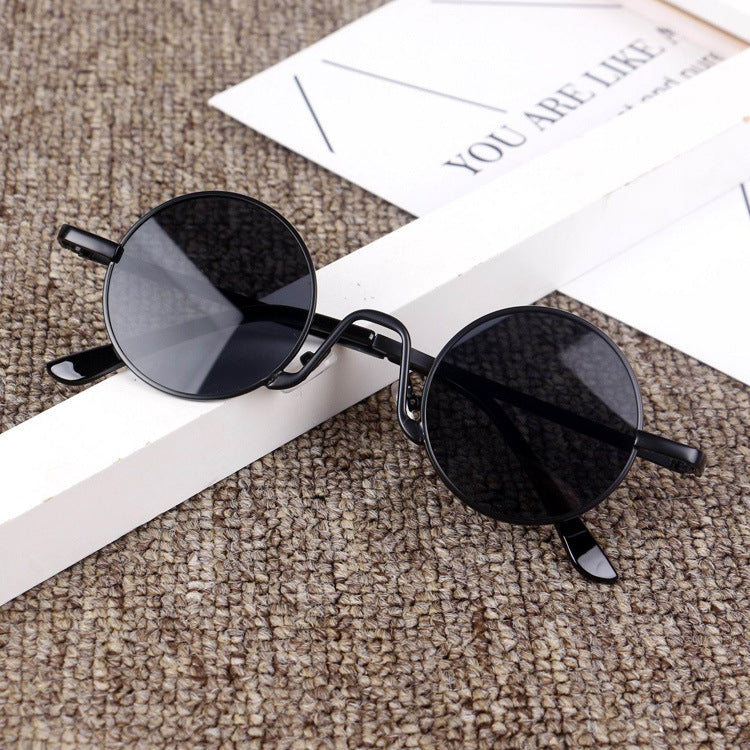 Stylish round black sunglasses on textured fabric, modern eyewear by FashionRay