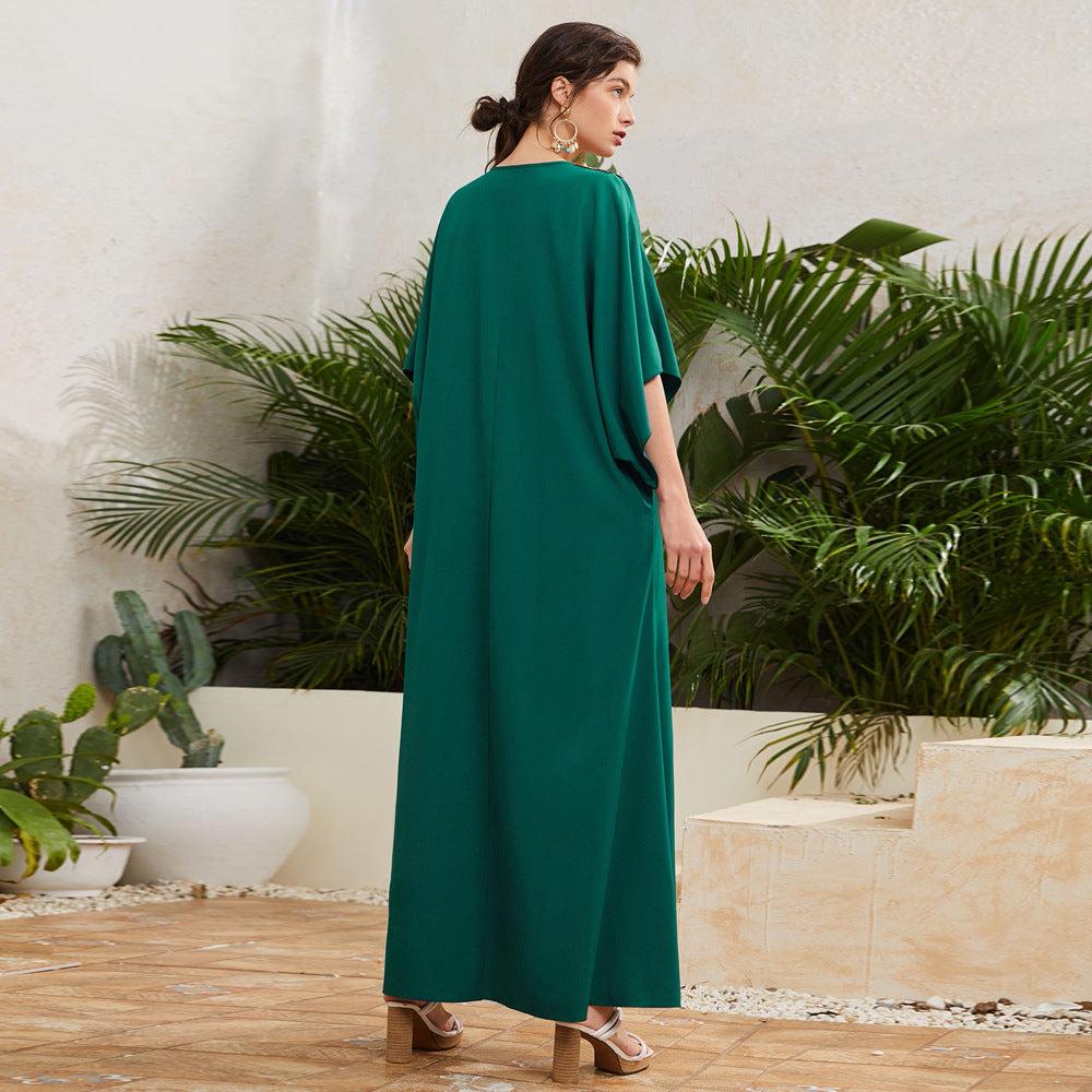 Woman in green maxi dress standing outdoors with plants, FashionRay trendy comfortable style