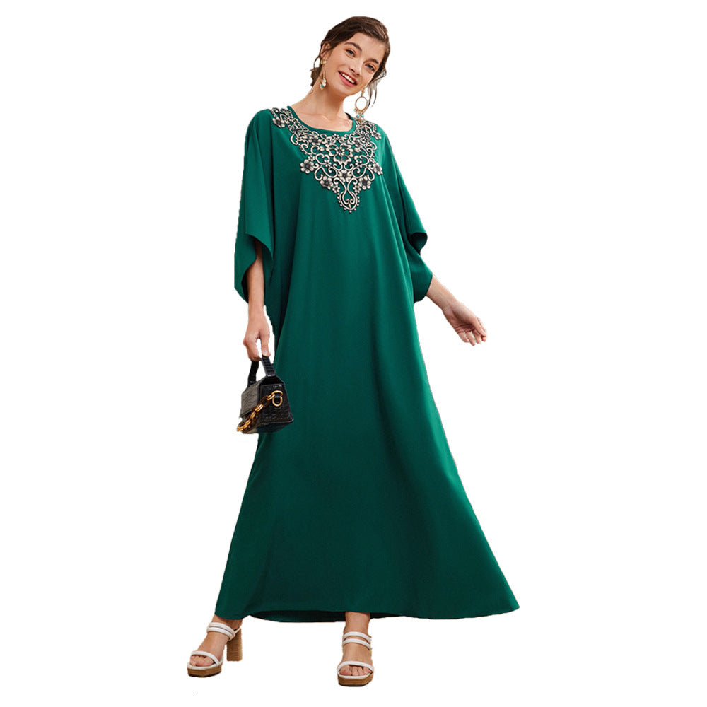 Woman modeling green embellished maxi dress with handbag and sandals, FashionRay style