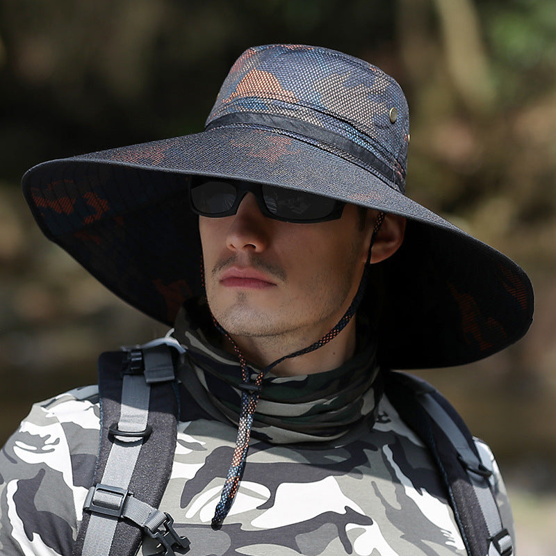 Man in camo shirt and wide-brim sun hat with sunglasses outdoors, FashionRay style