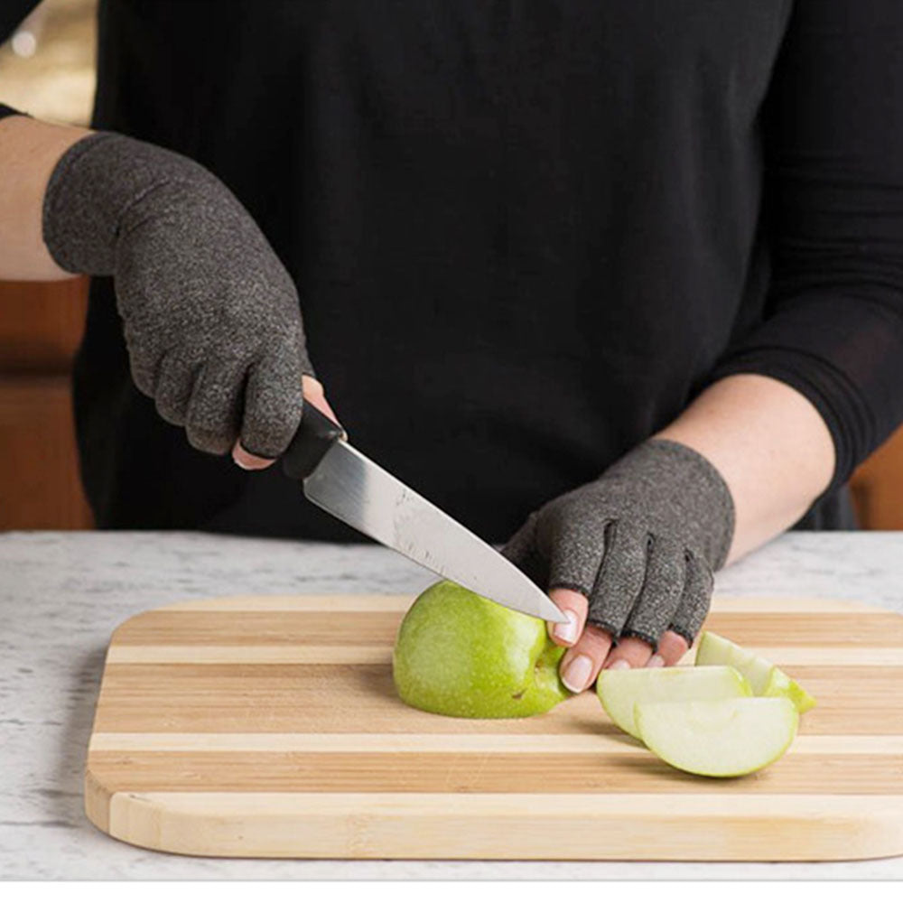 Person wearing cut-resistant gloves slicing green apple on wood cutting board, FashionRay kitchen accessory