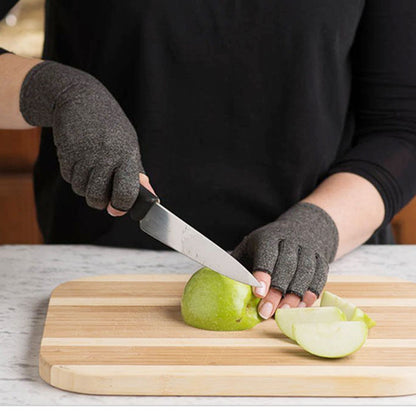 Person wearing cut-resistant gloves slicing green apple on wood cutting board, FashionRay kitchen accessory