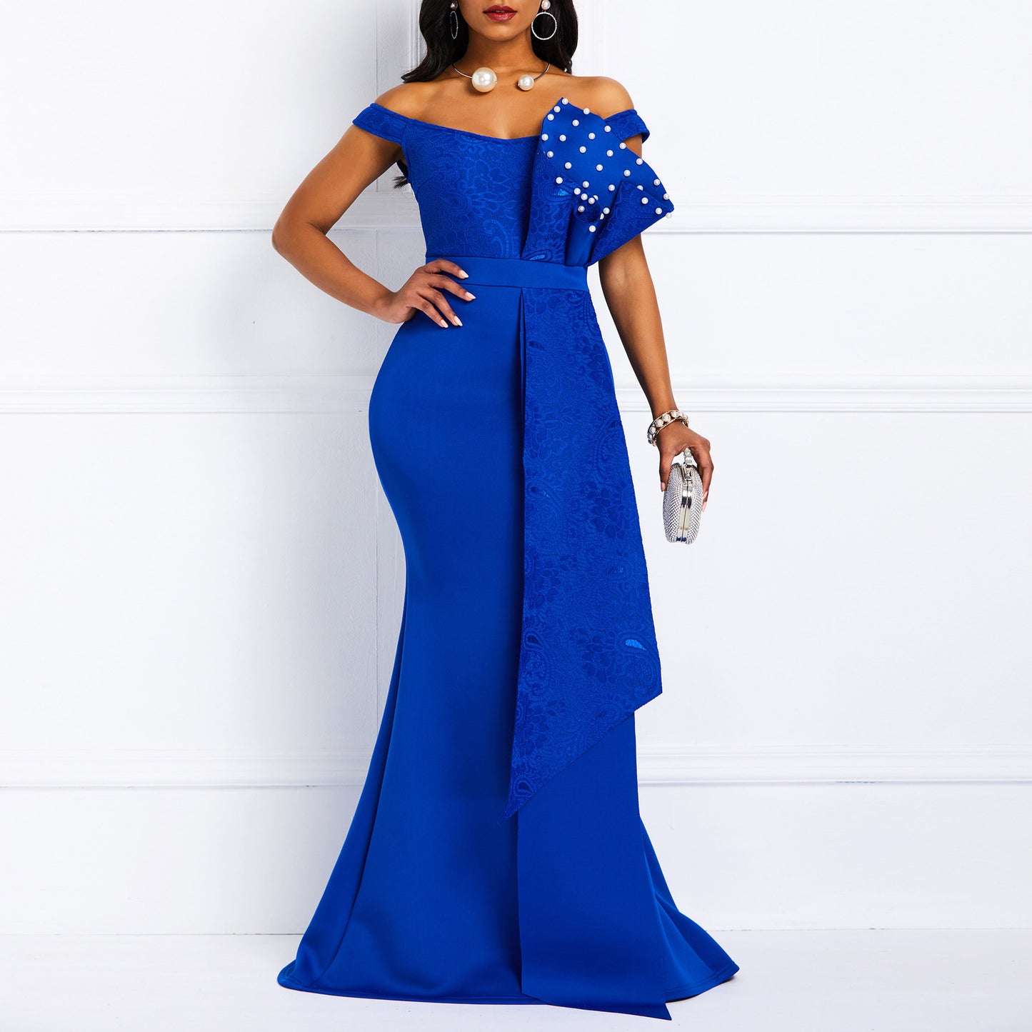 Woman in elegant royal blue off-shoulder gown with pearl embellishments, FashionRay style