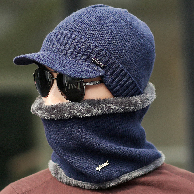 Man wearing navy knit hat, matching neck warmer with gray trim, and sunglasses, FashionRay style