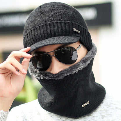 Man wearing black knit winter hat with visor and matching neck warmer, sunglasses, FashionRay style