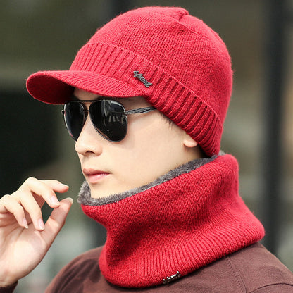 Man wearing red knit beanie with visor, matching neck warmer, and sunglasses, FashionRay style