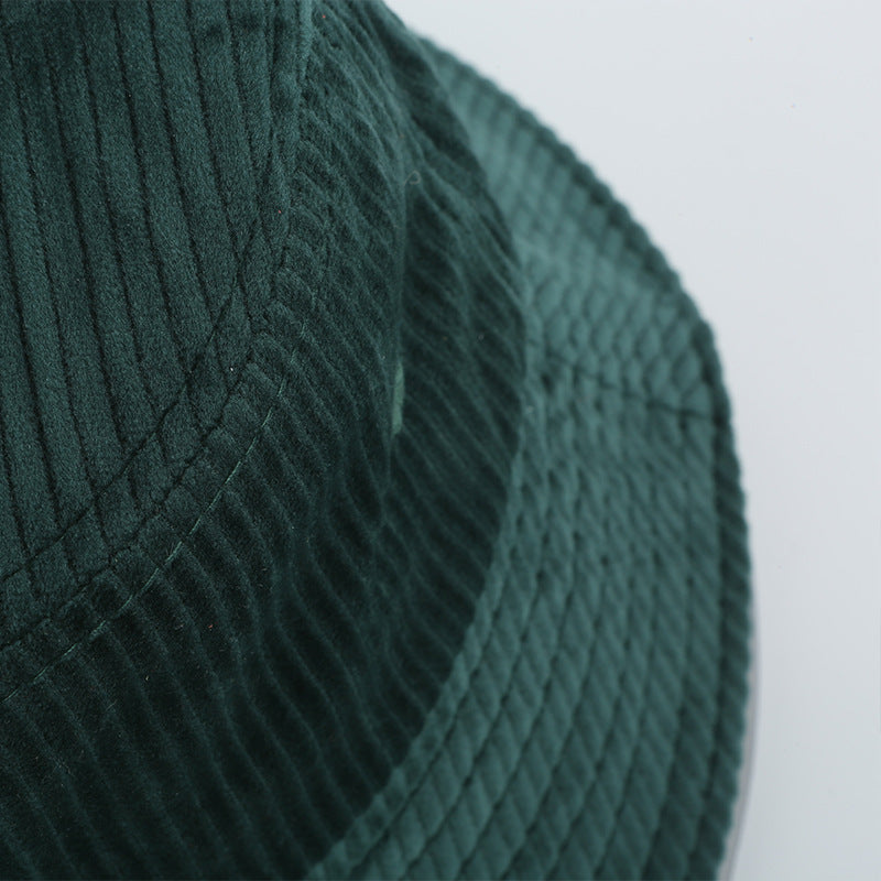 Close-up of a green corduroy bucket hat, textured fabric detail, FashionRay style