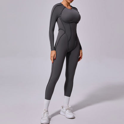 Woman wearing a sleek gray long-sleeve jumpsuit with white sneakers, FashionRay activewear