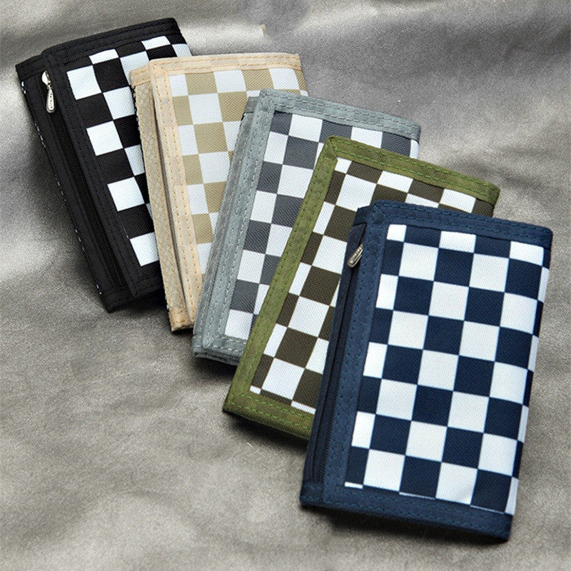 FashionRay checkered wallets in black, beige, grey, green, and blue on a grey surface