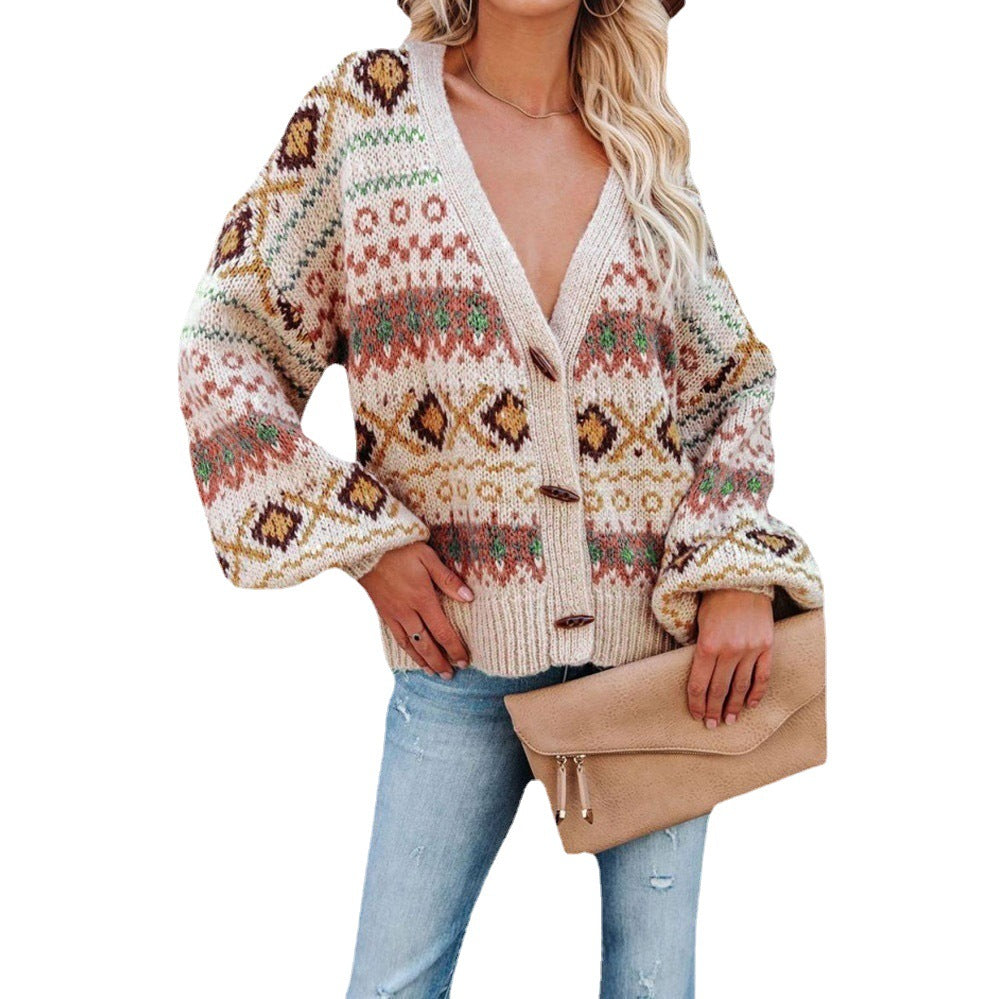 Woman wearing a colorful knit cardigan and jeans, holding a tan clutch, FashionRay style.