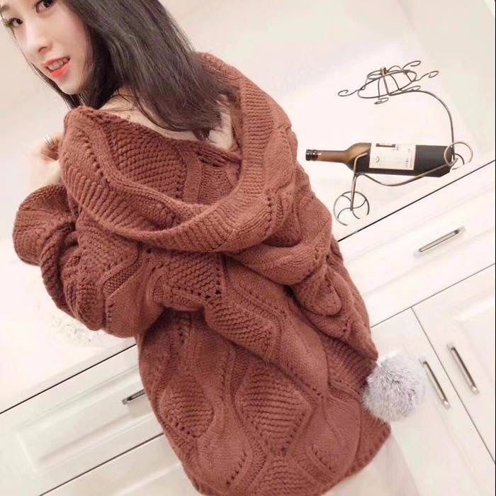 Woman wearing oversized brown knit sweater in modern kitchen, cozy fashion style from FashionRay