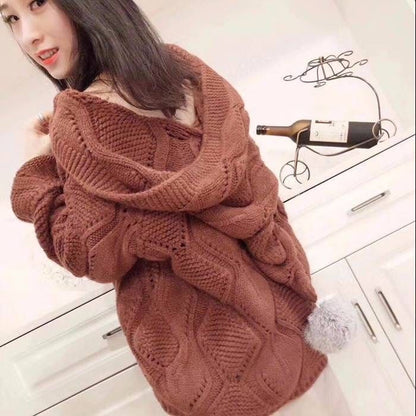 Woman wearing oversized brown knit sweater in modern kitchen, cozy fashion style from FashionRay