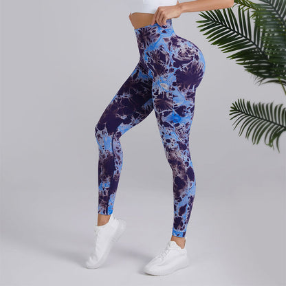 Woman modeling high-waisted blue tie-dye leggings and white sneakers, FashionRay activewear