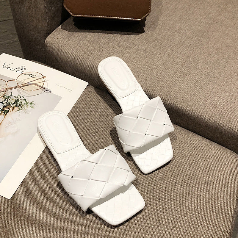 White woven slide sandals on beige sofa, stylish women's footwear from FashionRay