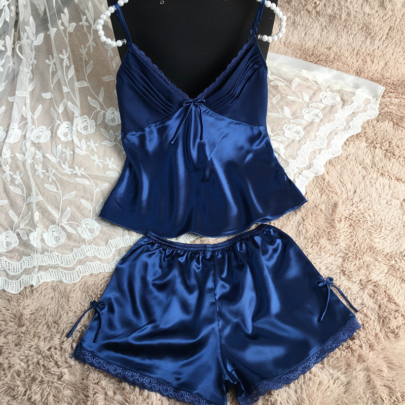 Navy blue satin pajama set with lace trim on soft beige rug, FashionRay sleepwear