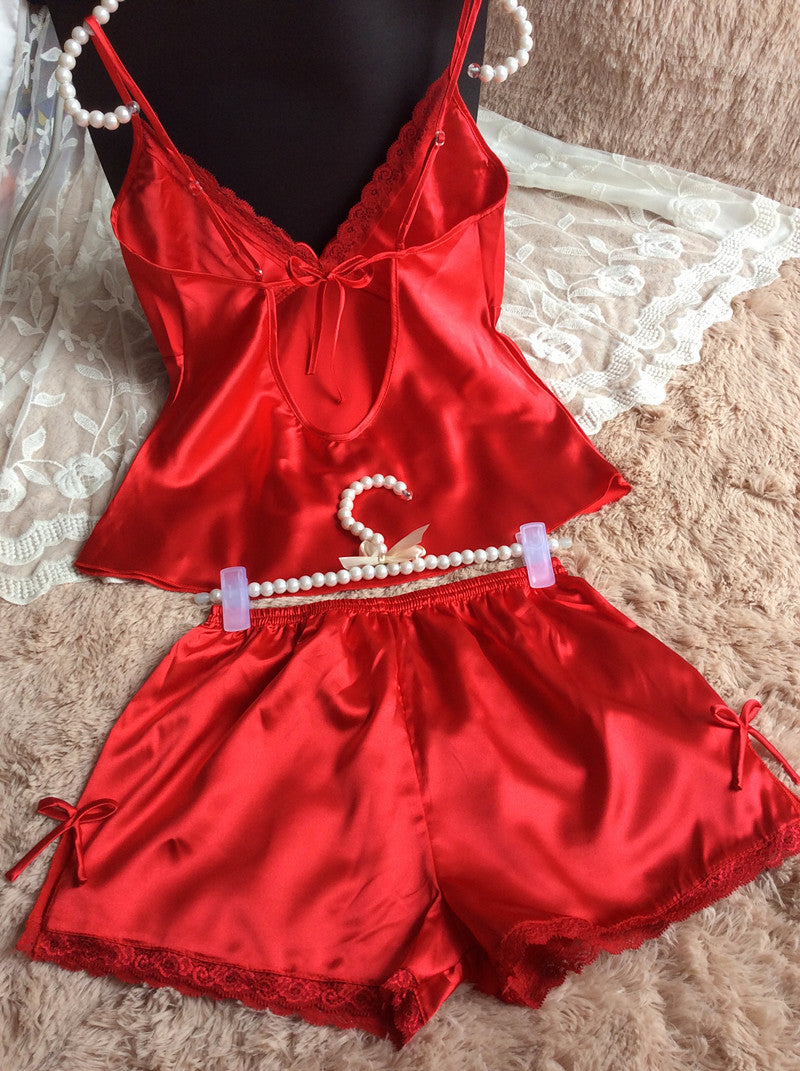 Red satin lace trim pajama set with camisole top and shorts on FashionRay, displayed on soft fabric.