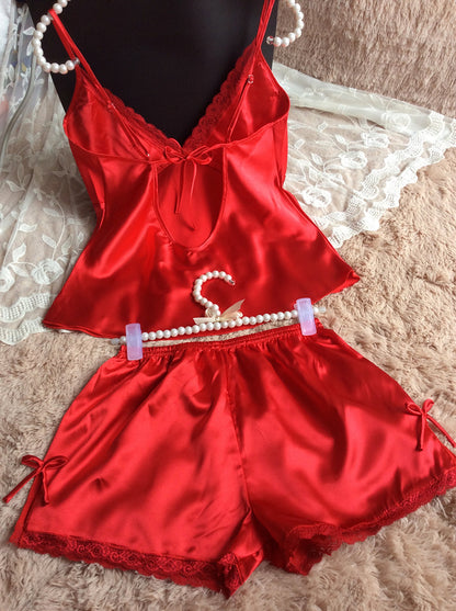 Red satin lace trim pajama set with camisole top and shorts on FashionRay, displayed on soft fabric.