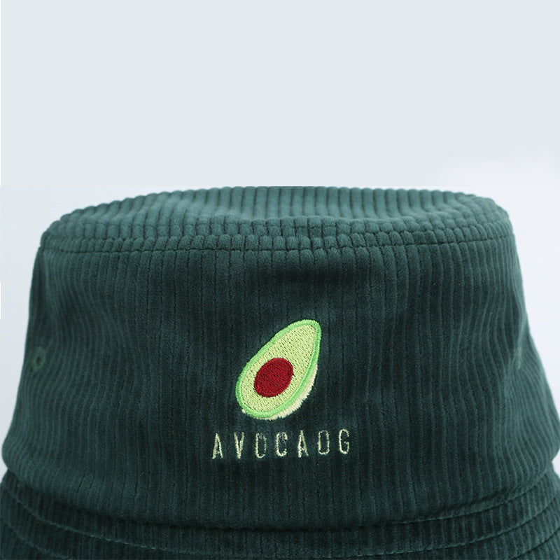 Dark green corduroy bucket hat with embroidered avocado design and AVOCADO text, FashionRay accessory