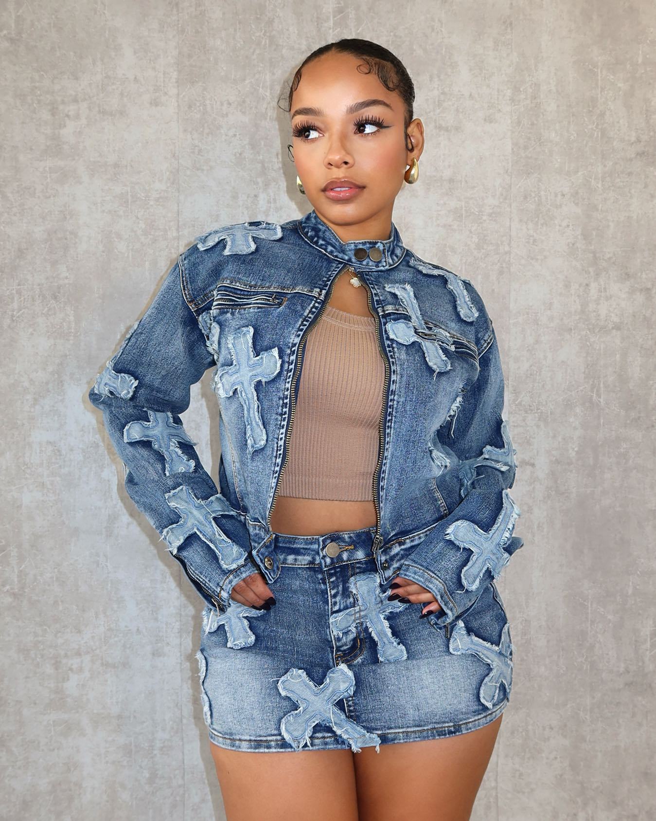 Model in trendy denim jacket and skirt set with bold cross patches, FashionRay style