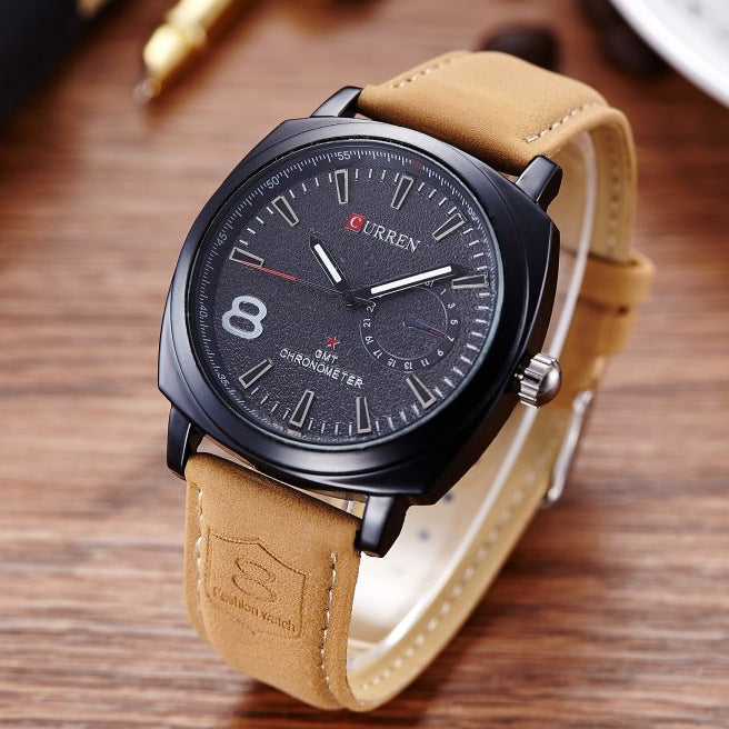 Men's Curren black dial watch with tan leather strap on wood table, FashionRay accessory