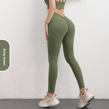 Woman wearing FashionRay army green leggings and sports bra against white wall