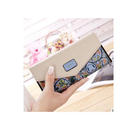 Hand holding a beige and floral patterned wallet, FashionRay trendy accessories