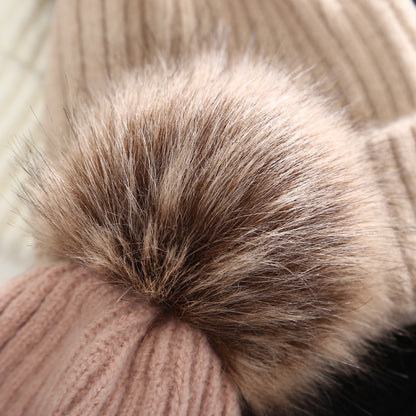 Close-up of a beige knit beanie with faux fur pom pom, cozy winter fashion from FashionRay