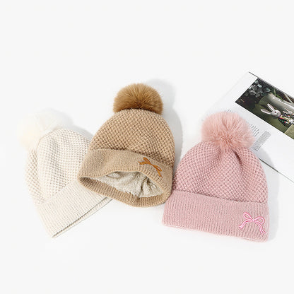 Trendy knit pom pom beanies in cream, beige, and pink on white background, FashionRay style.