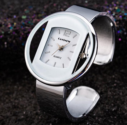 Modern silver oval wristwatch with white face, FashionRay trendy accessory on dark background