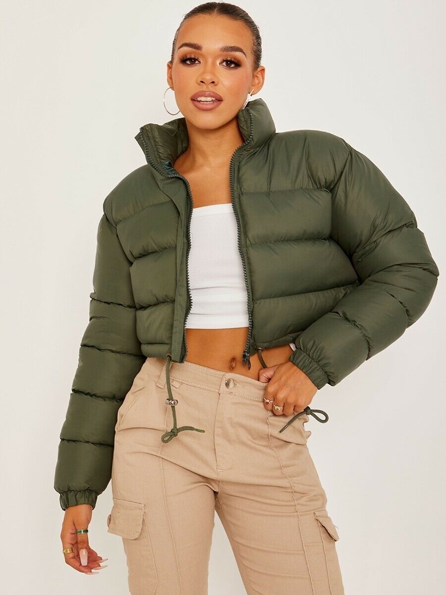 Woman in cropped green puffer jacket, white crop top, and beige cargo pants, FashionRay style