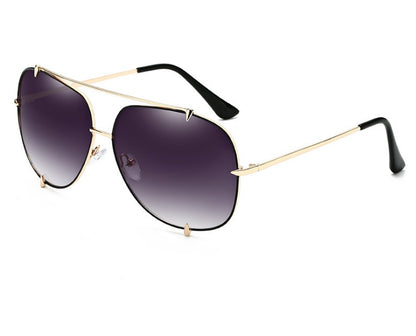 Trendy aviator sunglasses with gold frame and gradient dark lenses on white background
