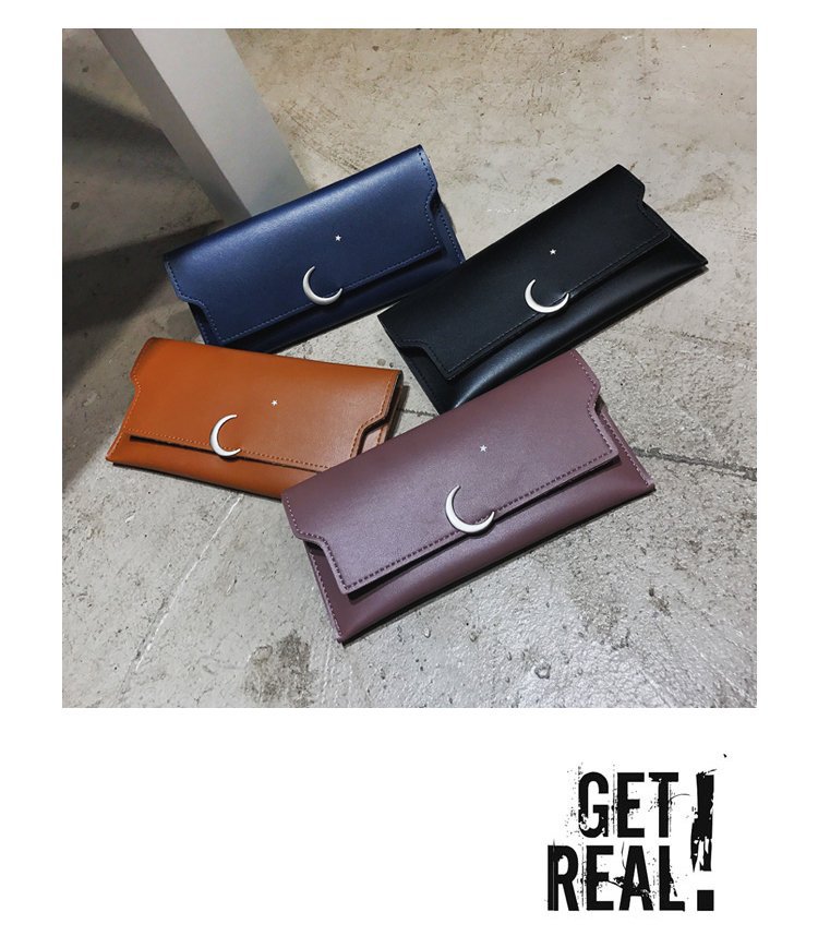 Four FashionRay crescent moon wallets in blue, black, brown, and mauve on concrete floor