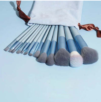 FashionRay blue makeup brush set with soft bristles and white pouch on light blue background