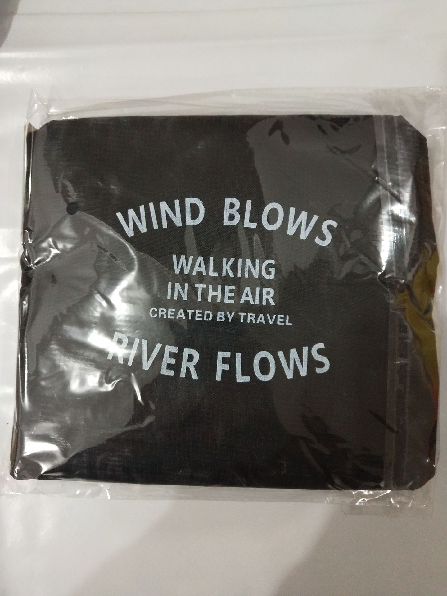 Black folded FashionRay travel pouch with white text, packaged in clear plastic.