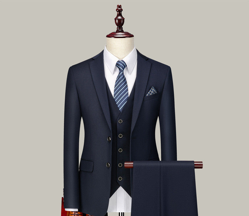 Navy blue three-piece suit with striped tie and pocket square on mannequin, FashionRay style