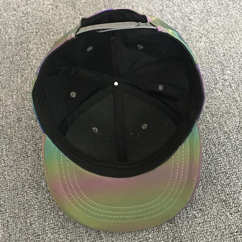 Iridescent snapback cap with black interior on gray carpet, trendy FashionRay accessory