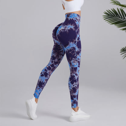 Woman modeling blue tie-dye high-waisted leggings and white crop top, FashionRay activewear