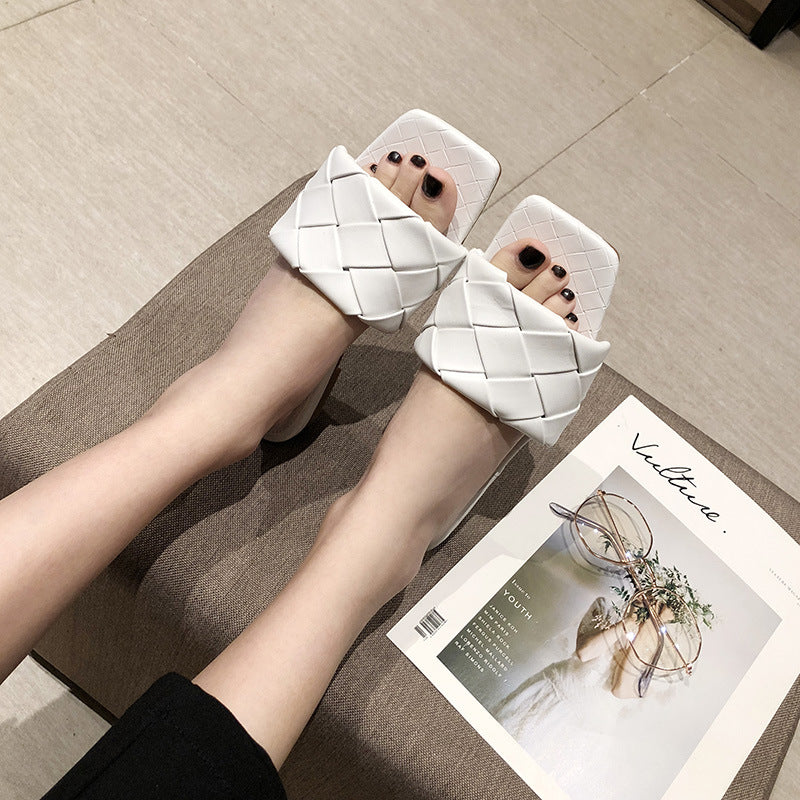 Woman wearing FashionRay white woven slide sandals, sitting indoors with fashion magazine