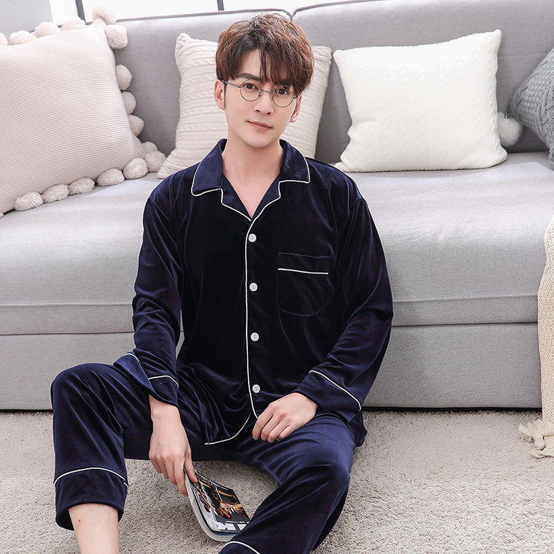 Man in navy velvet pajama set sitting on sofa, FashionRay cozy loungewear style