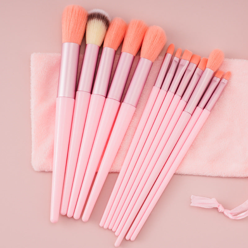 Set of pink makeup brushes with soft bristles on pink cloth, FashionRay beauty accessory
