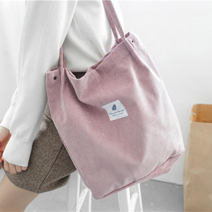 Trendy pink corduroy tote bag carried by woman, stylish casual accessory from FashionRay