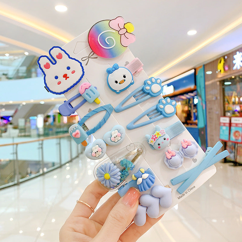 Cute blue hair clip set with animal and flower designs held in a stylish shopping mall