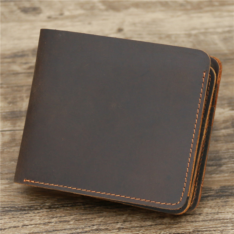 Brown leather wallet with visible stitching on rustic wooden surface, FashionRay accessories