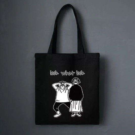Black FashionRay tote bag with graphic cartoon figures and 'look what look' text