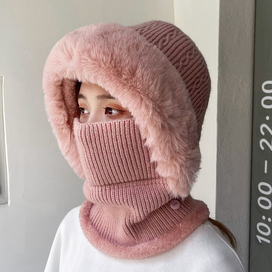 Woman wearing pink knit faux fur hood and face cover, cozy winter fashion by FashionRay