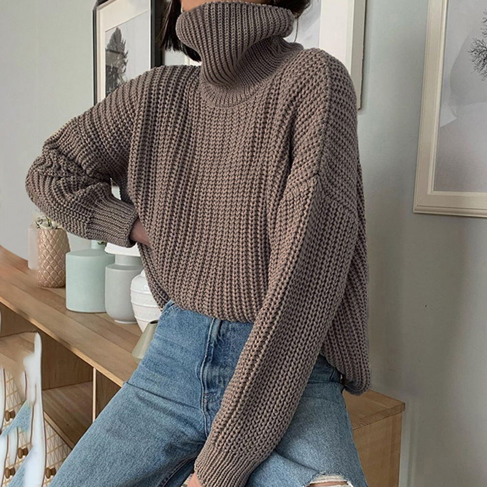 Woman in chunky brown turtleneck sweater and blue jeans, stylish casual FashionRay look